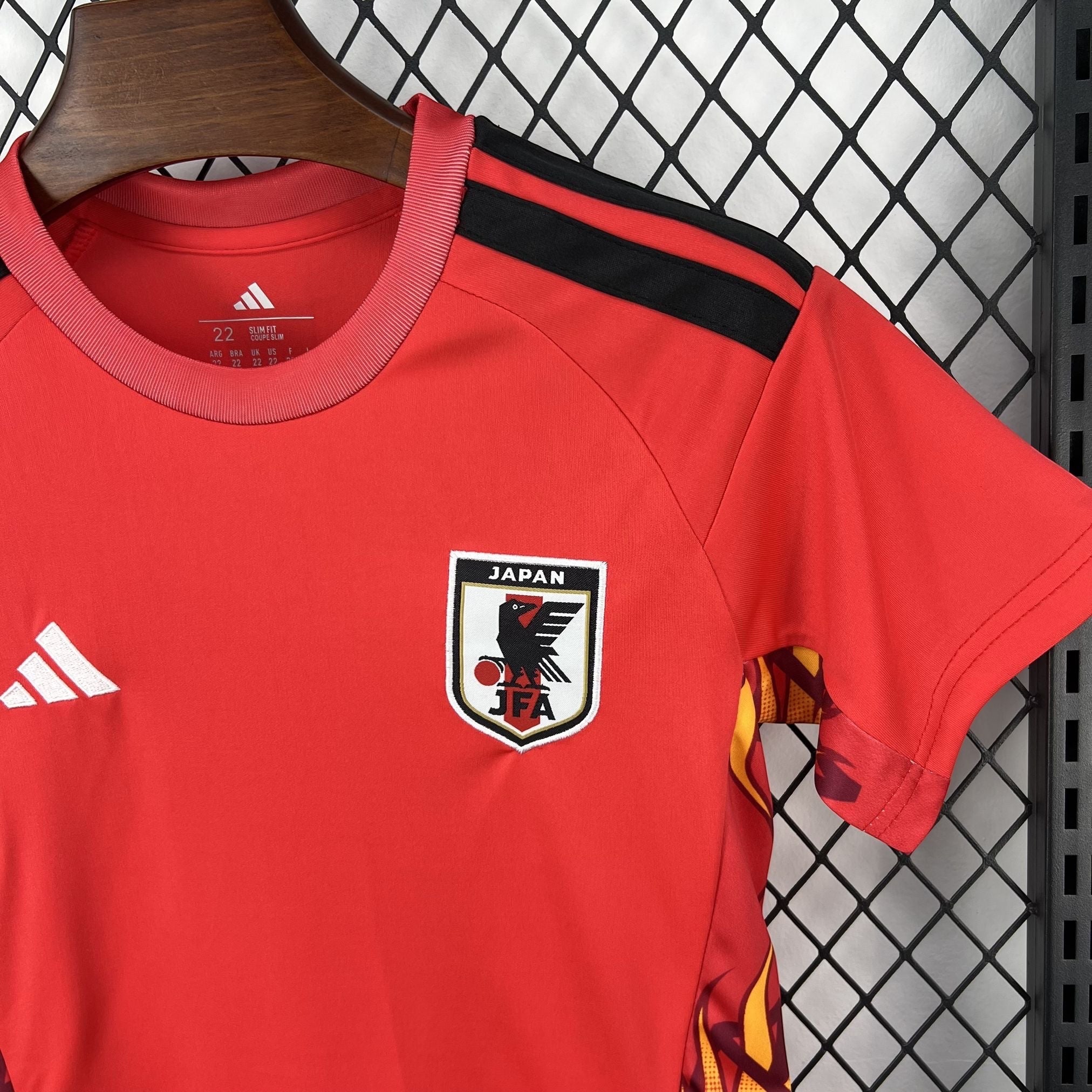 Leazofoot Japan kids' red short-sleeve soccer jersey with black stripes on shoulders and JFA crest.