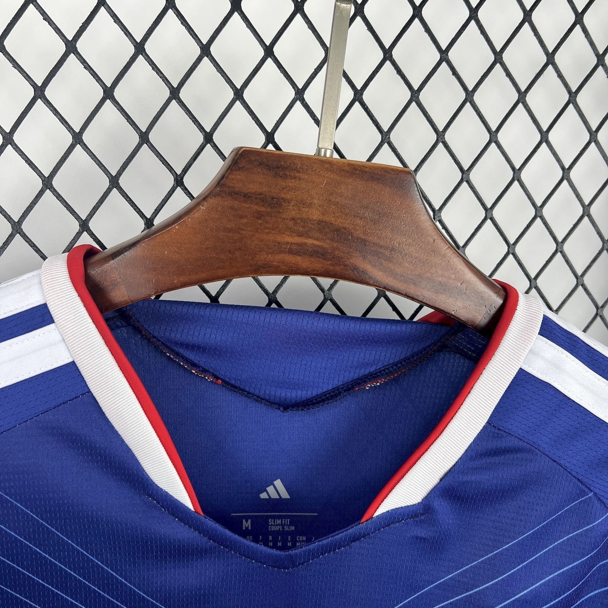 Leazofoot Japan home soccer jersey 2026, blue with white and red trim on collar and white stripes on sleeves.