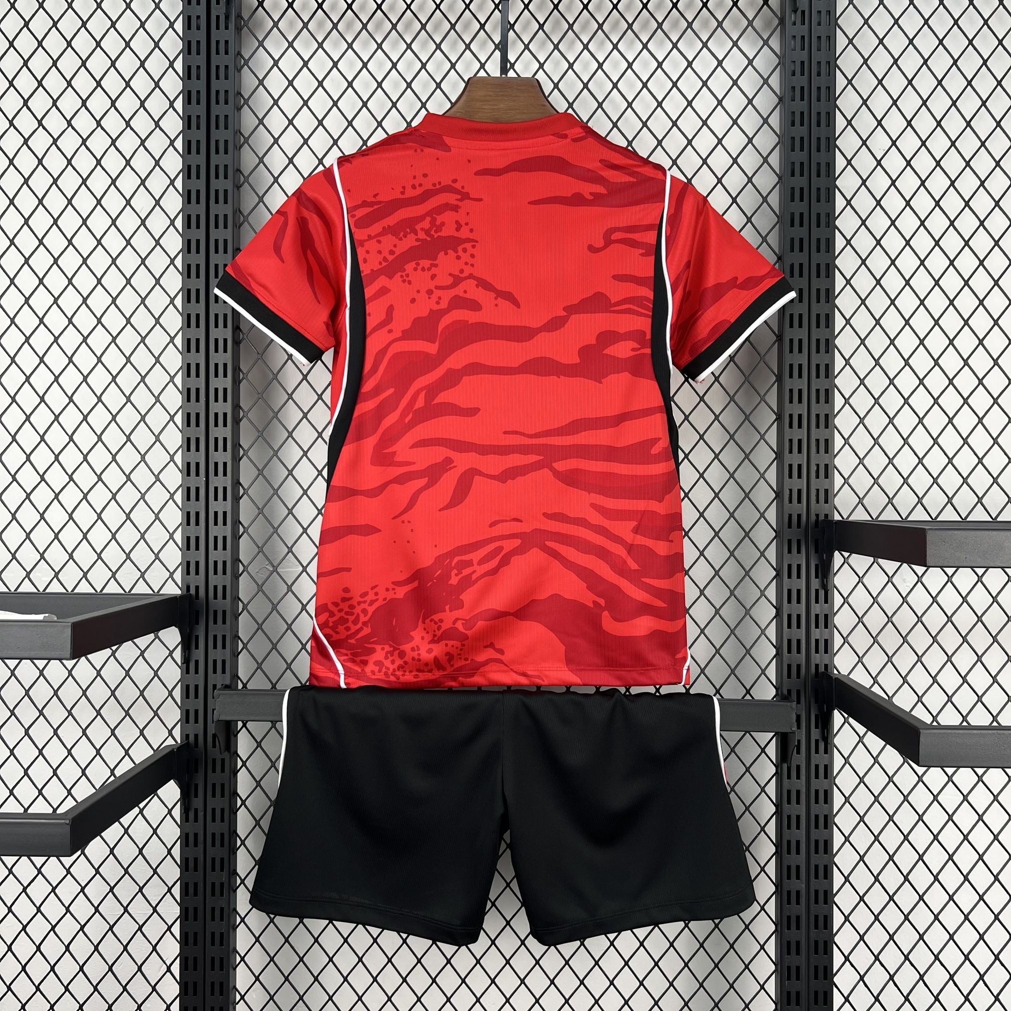 Leazofoot red and black kids' soccer uniform with tiger stripe pattern on jersey and white trim.