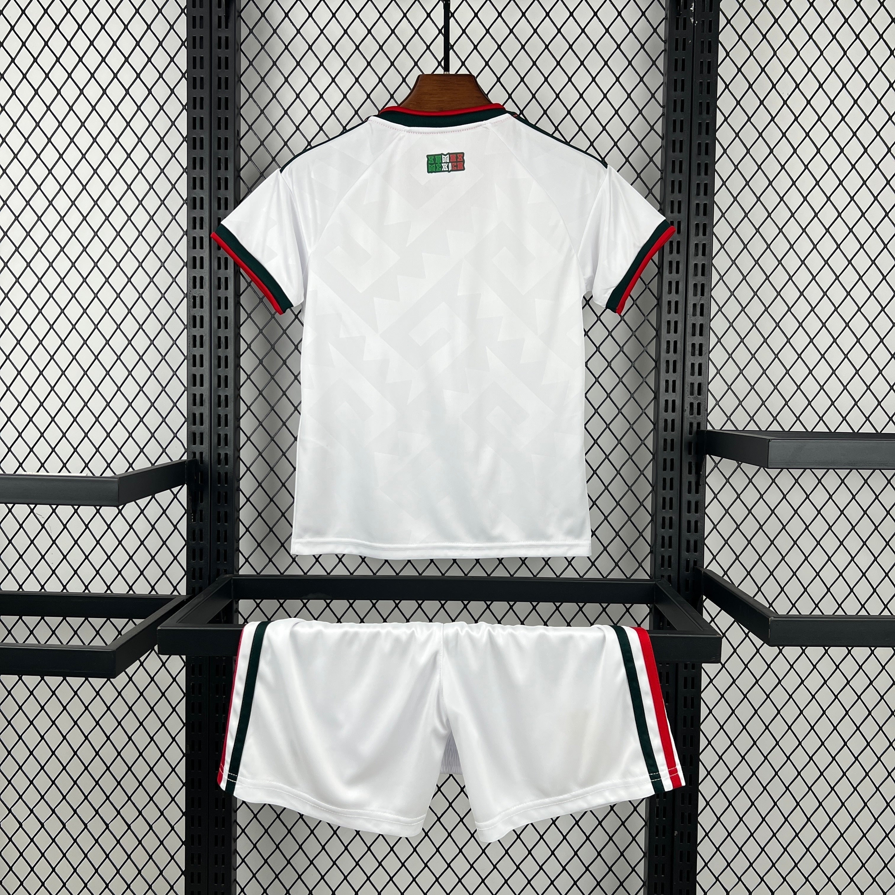 Leazofoot white polyester kids' soccer uniform with red and green trim on collar and sleeves. Matching shorts with striped trim.