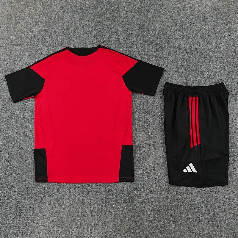Leazofoot Manchester United 26/27 training kit featuring a red and black jersey and matching black shorts with stripes.