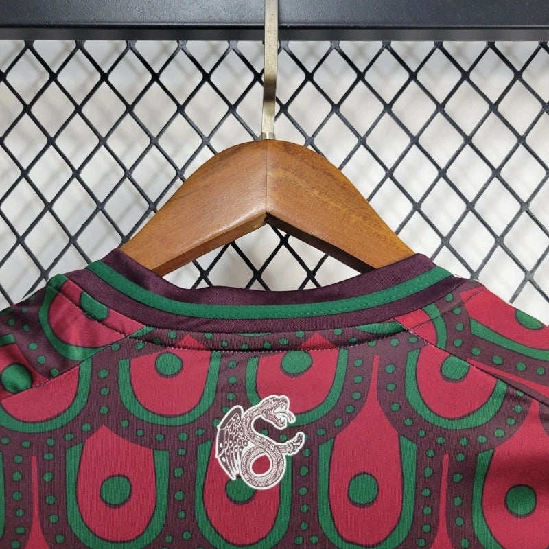 Leazofoot Mexico 2024 home soccer jersey featuring a maroon and green patterned design with a serpent emblem.