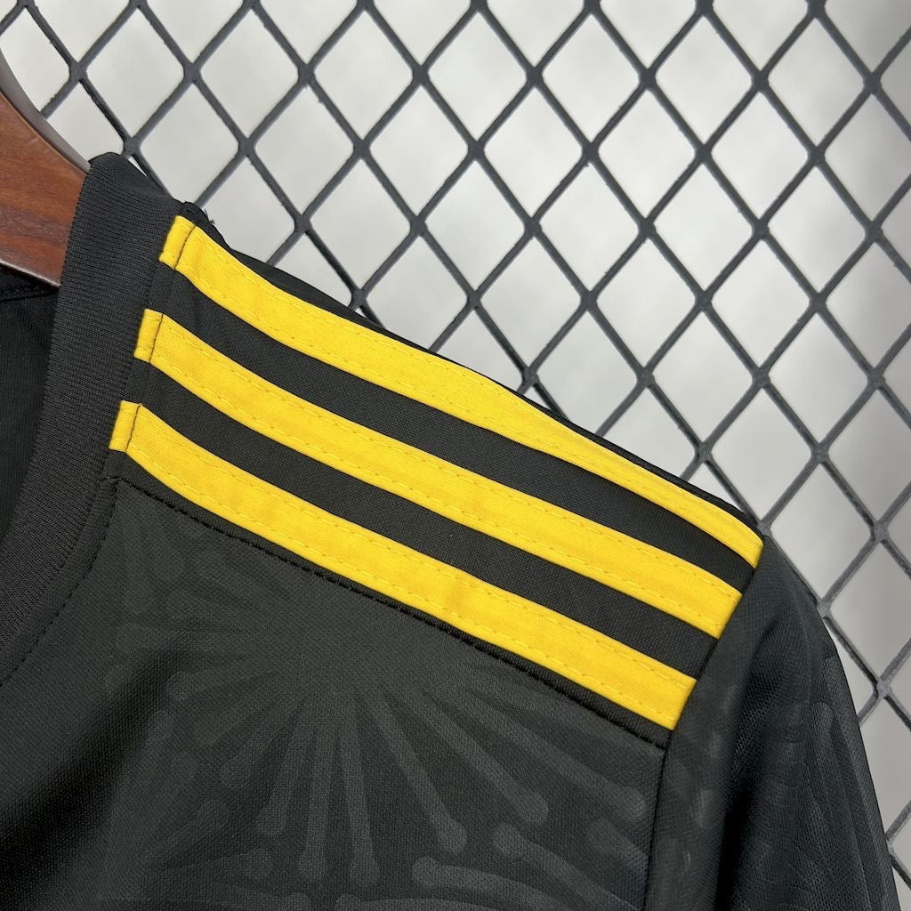 Leazofoot Mexico 2025 concept soccer jersey in black with yellow three-stripe shoulder detail and subtle patterns.