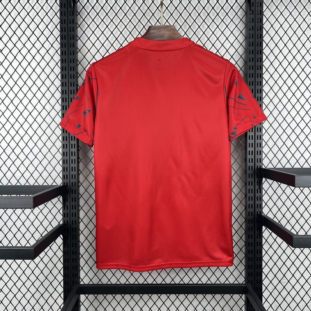 Leazofoot Mexico 2026 pre-match soccer jersey in red with black geometric sleeve patterns on a display rack.