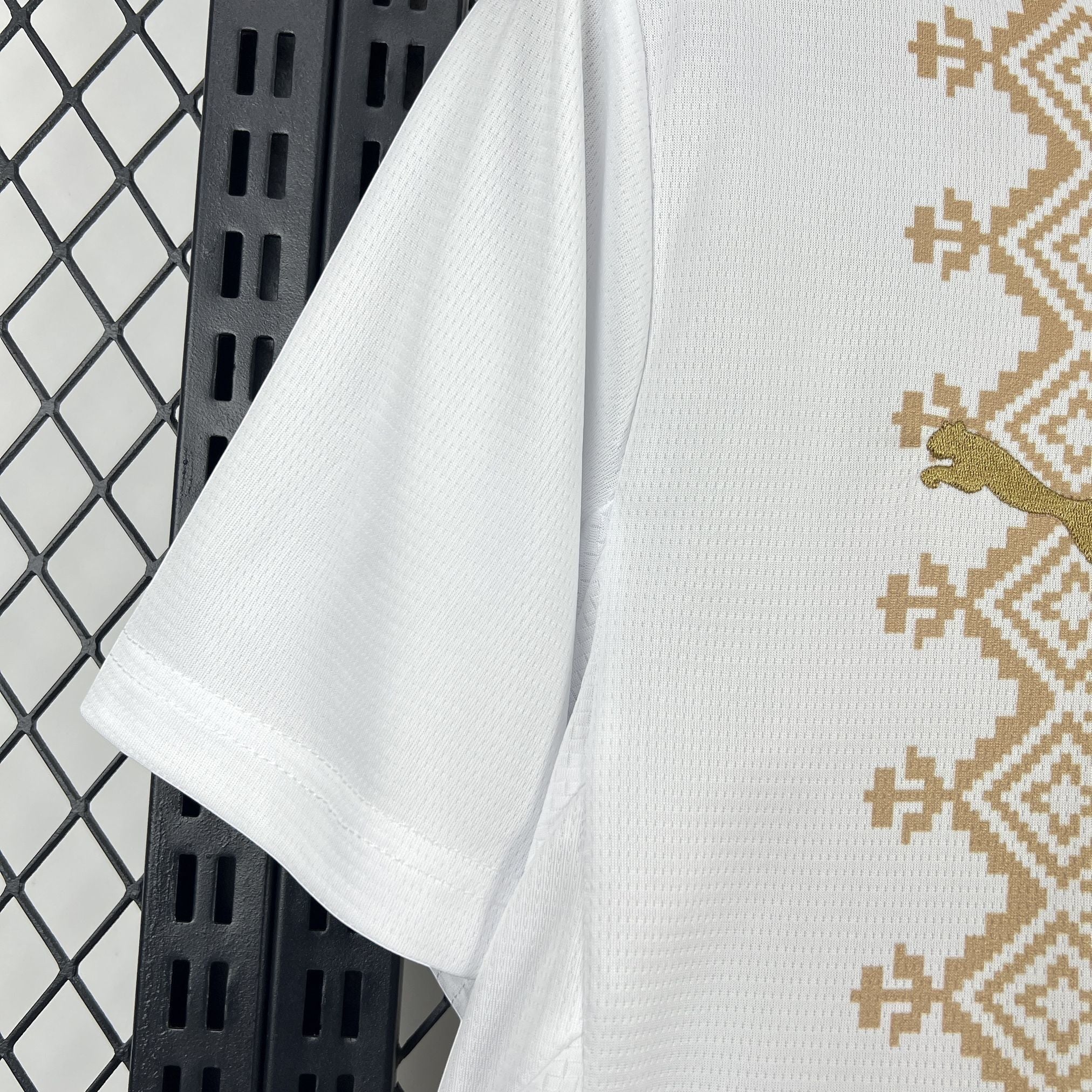Leazofoot white football jersey with gold geometric pattern and Puma logo, 2026 Morocco away kit.
