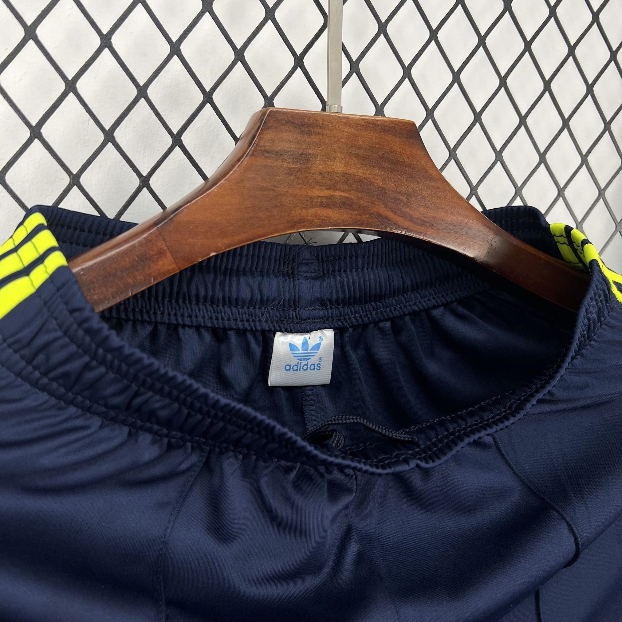 Leazofoot navy blue athletic shorts with yellow Adidas stripes on the waistband.