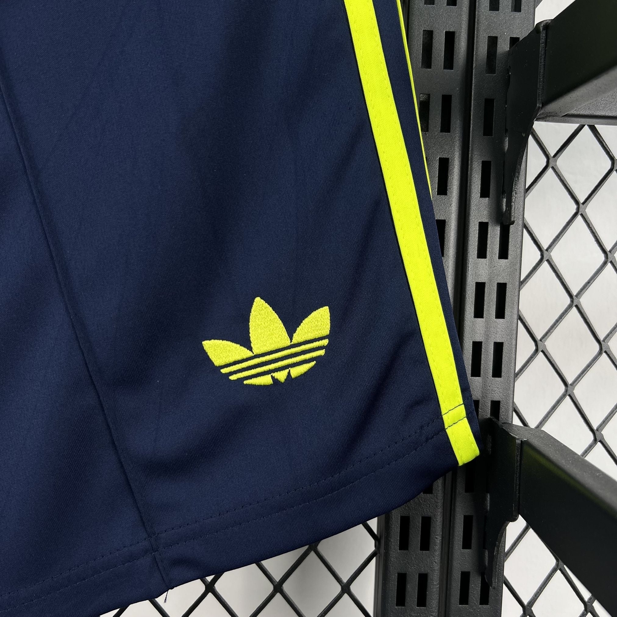 Leazofoot navy blue shorts with yellow Adidas logo and side stripes.