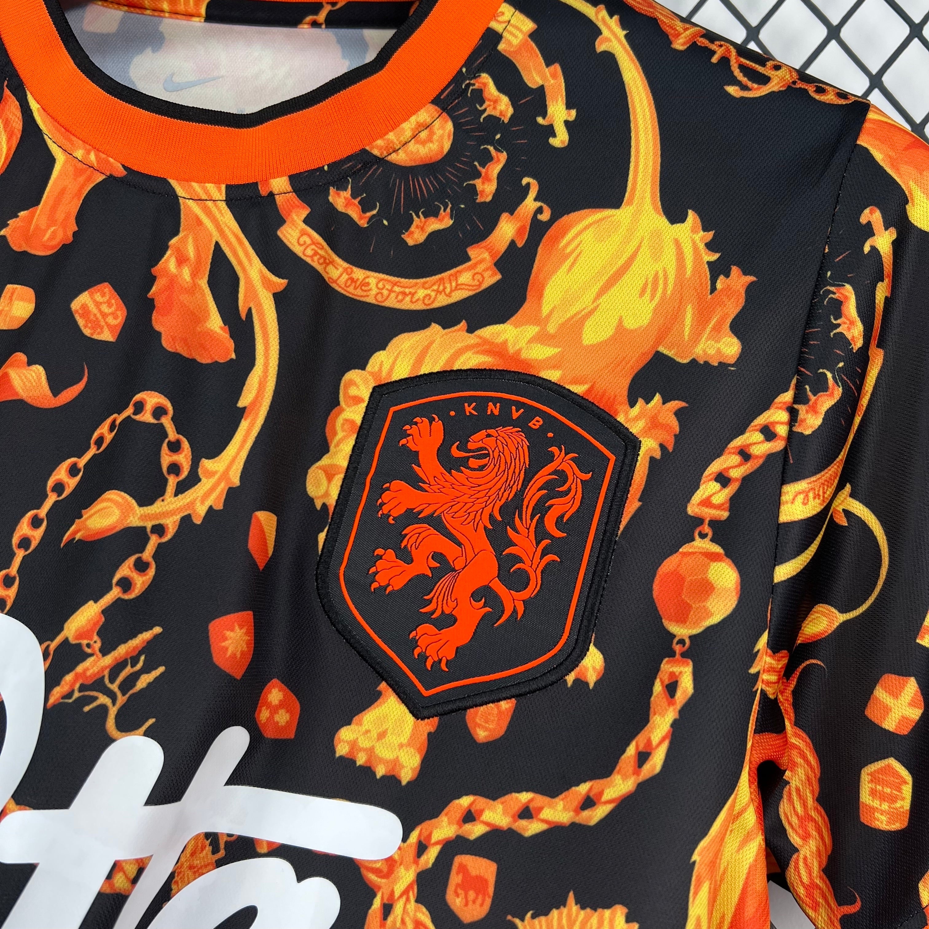 Leazofoot black football jersey with orange lion crest and flame-like pattern. Features "Got Love For All" text.