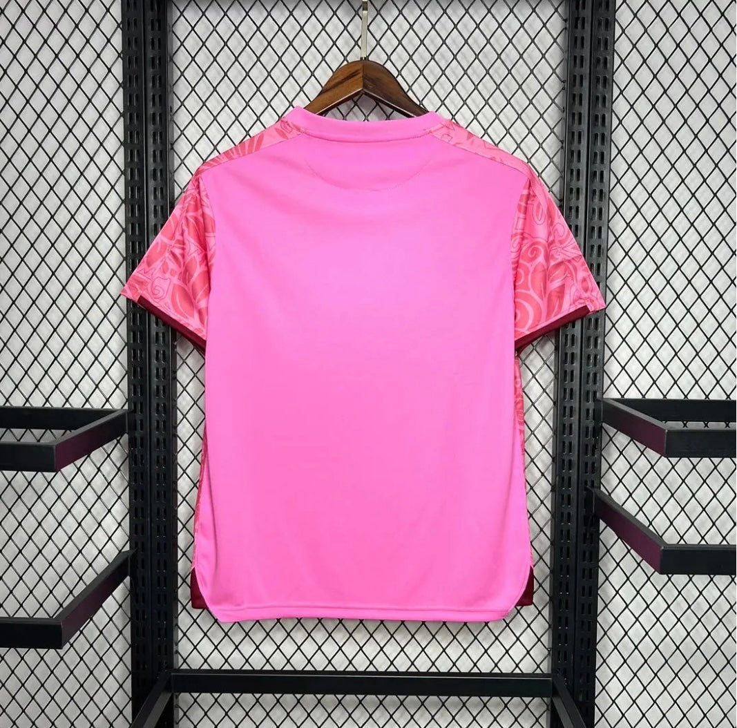 Leazofoot Palestine 2024 concept football jersey in bright pink with patterned sleeves on a wooden hanger