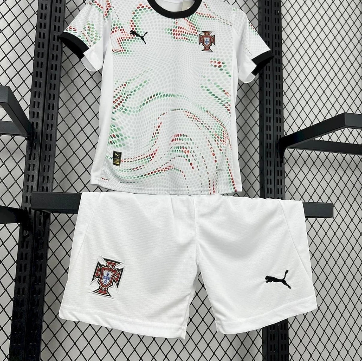Leazofoot Portugal 2025 away kids soccer kit with white jersey featuring green and red dot pattern and white shorts.