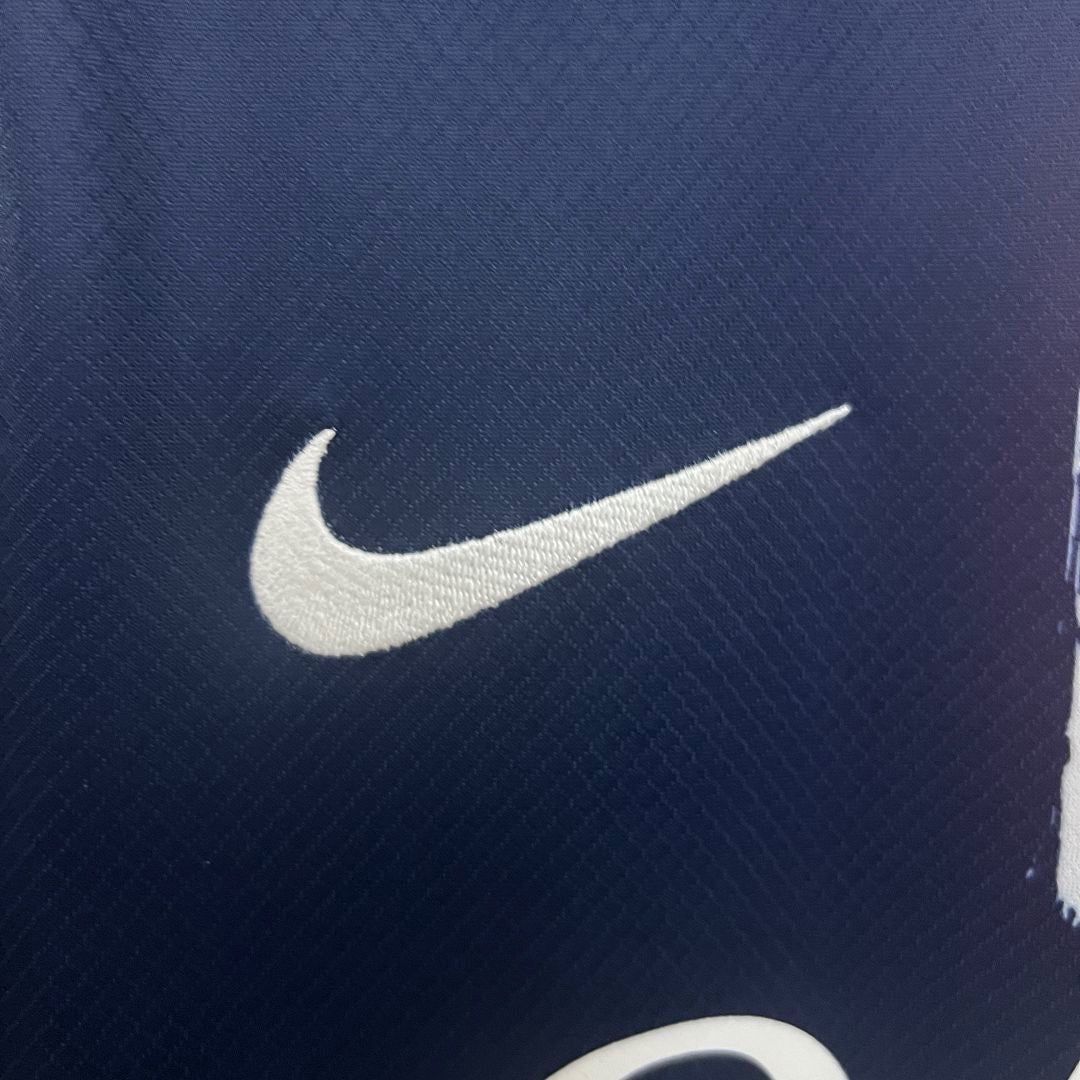 Leazofoot Paris Saint Germain 24/25 home jersey featuring a white embroidered Nike swoosh on navy blue fabric.