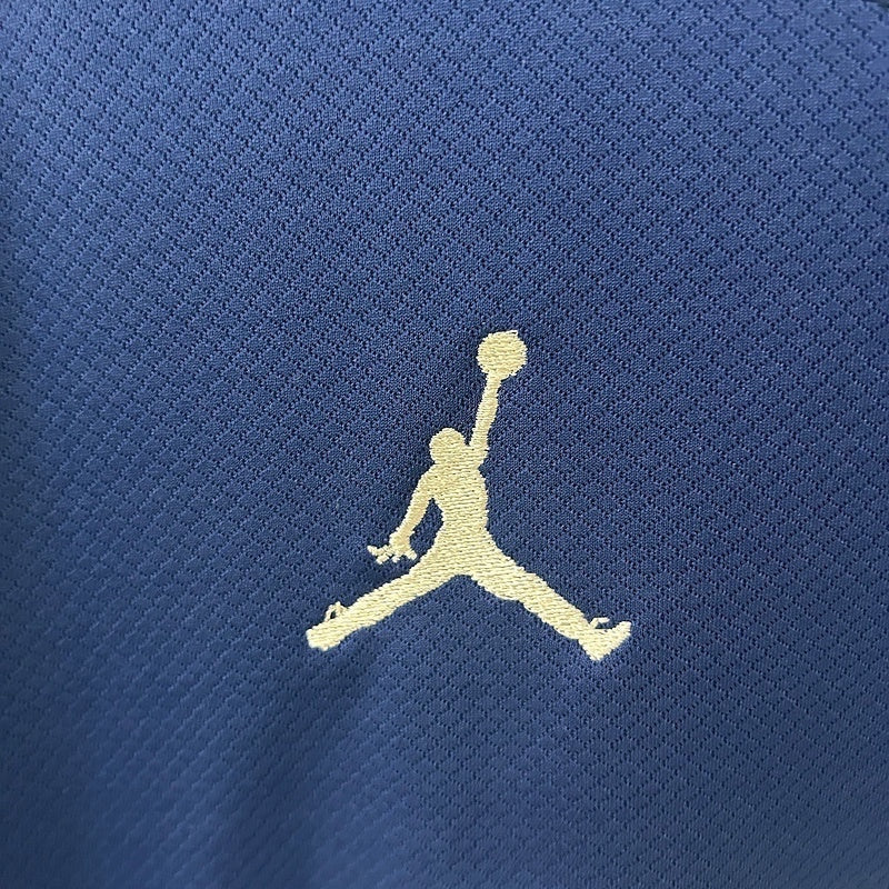 Leazofoot Paris Saint Germain 24/25 fourth jersey featuring a white embroidered Jordan logo on blue textured fabric.