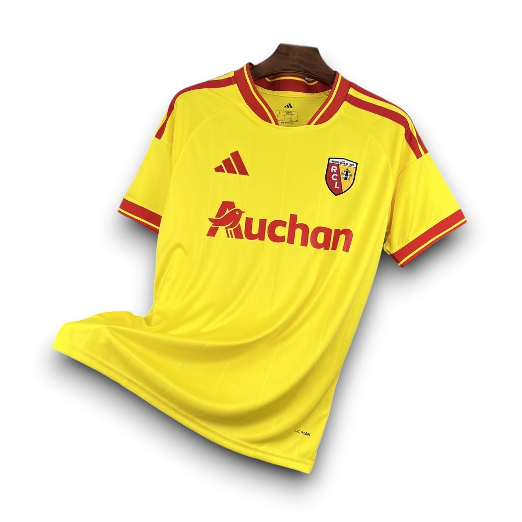 Leazofoot RC Lens 26/27 home football jersey in yellow and red with club crest and sponsor logo on a wire rack.