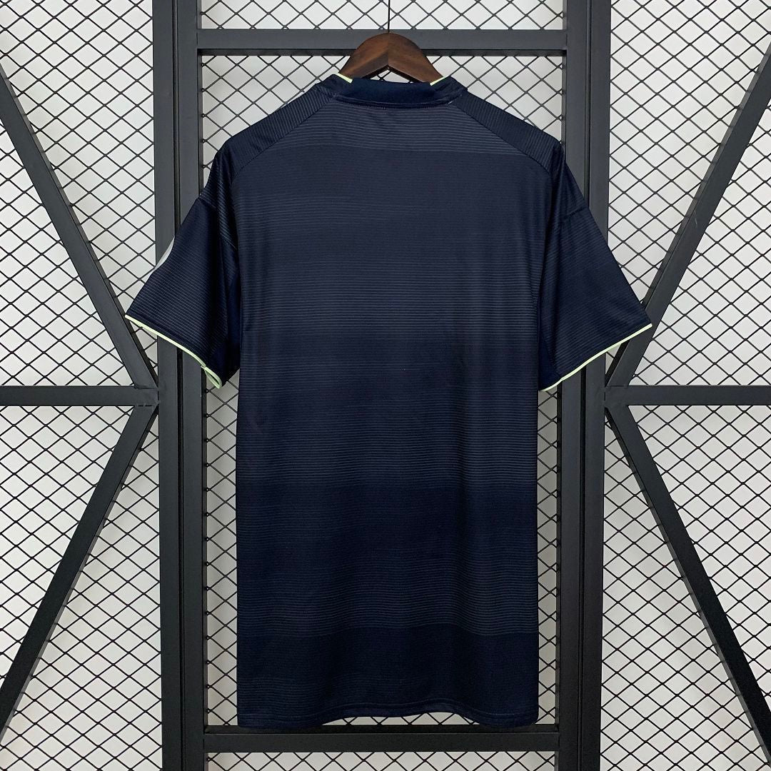 Back view of the Leazofoot Real Madrid 25/26 away jersey in dark navy with subtle horizontal stripes and lime trim.