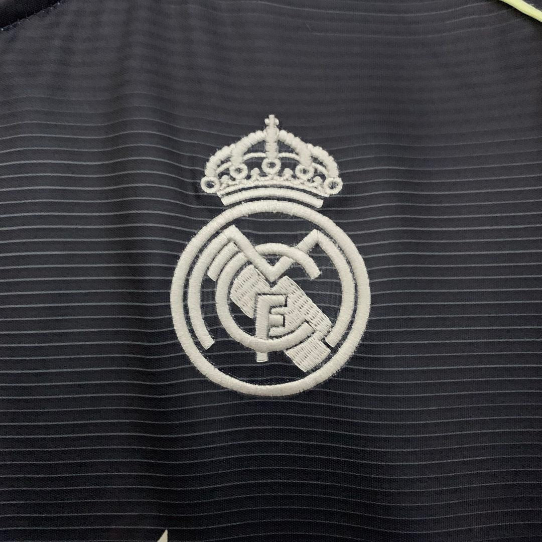 Leazofoot Real Madrid 25/26 away jersey featuring a white embroidered club crest on a dark textured fabric background