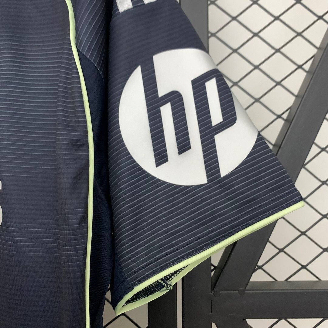 Leazofoot Real Madrid 25/26 away jersey sleeve detail featuring a dark navy fabric with subtle stripes and HP logo.