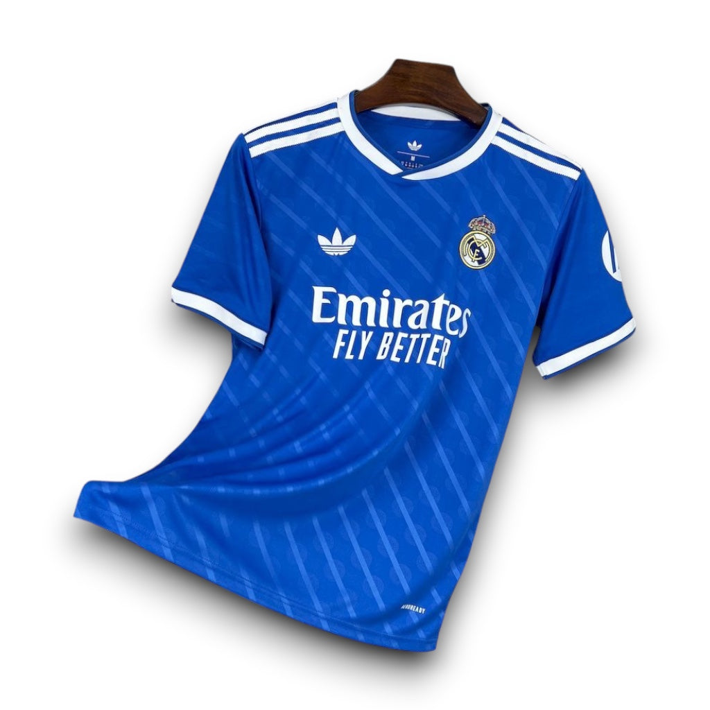 Leazofoot Real Madrid 25/26 third football jersey in blue with white stripes and team crest on a hanger