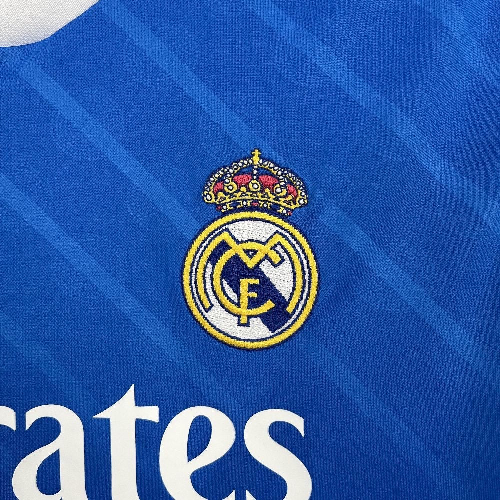 Leazofoot Real Madrid 25/26 third football jersey featuring an embroidered club crest on a blue textured fabric
