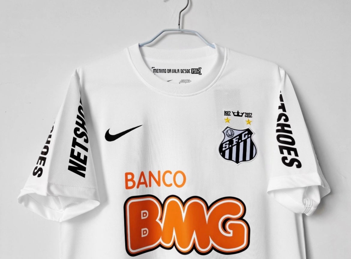 Leazofoot white 2012-2013 Santos away football jersey with Nike logo, club crest, and sponsor logos on a hanger.