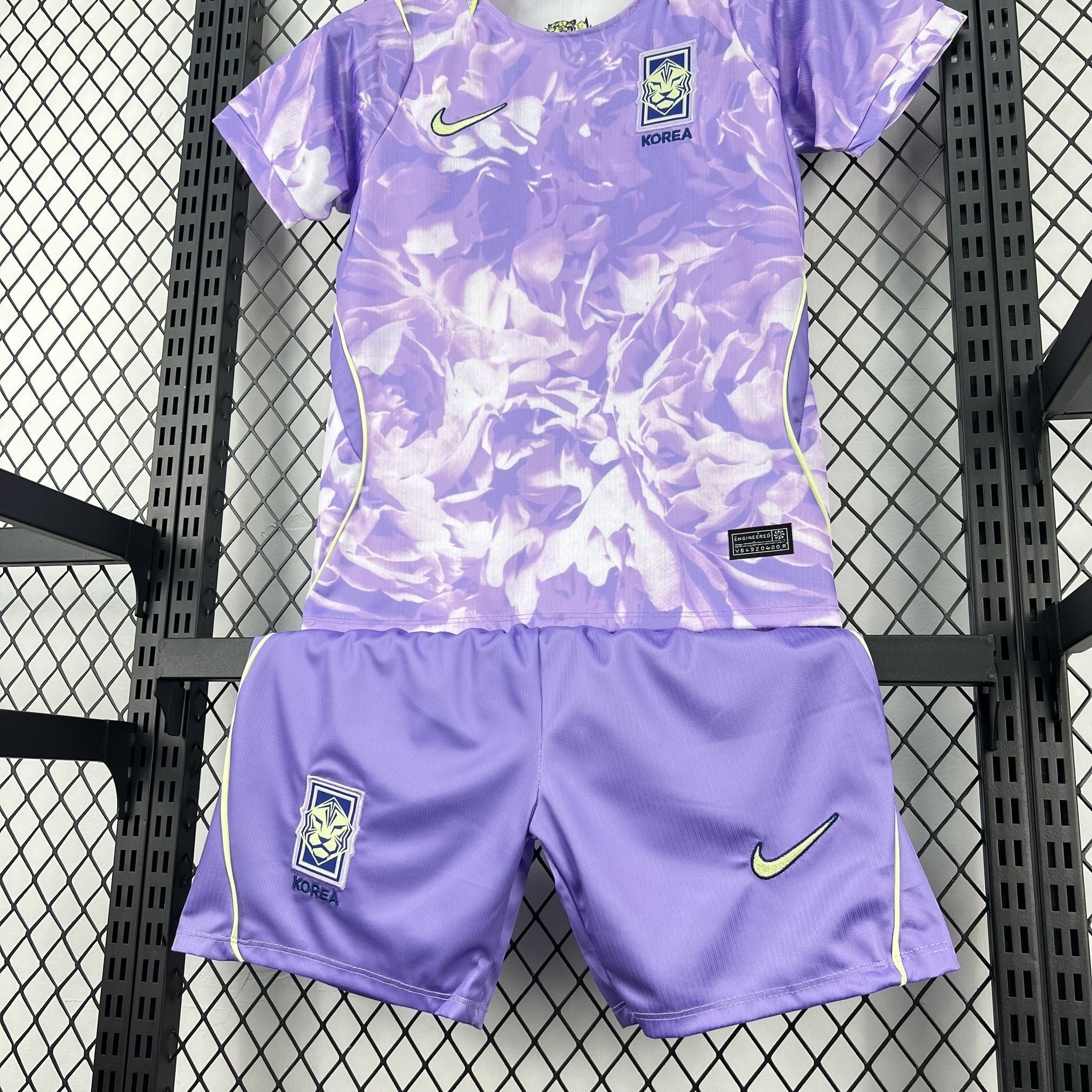 Leazofoot South Korea kids' soccer kit with purple floral print jersey and solid purple shorts. Features Nike logo.