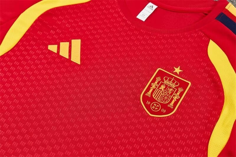 Leazofoot Spain 2026 training jersey in red with yellow accents, featuring the team crest and Adidas logo.