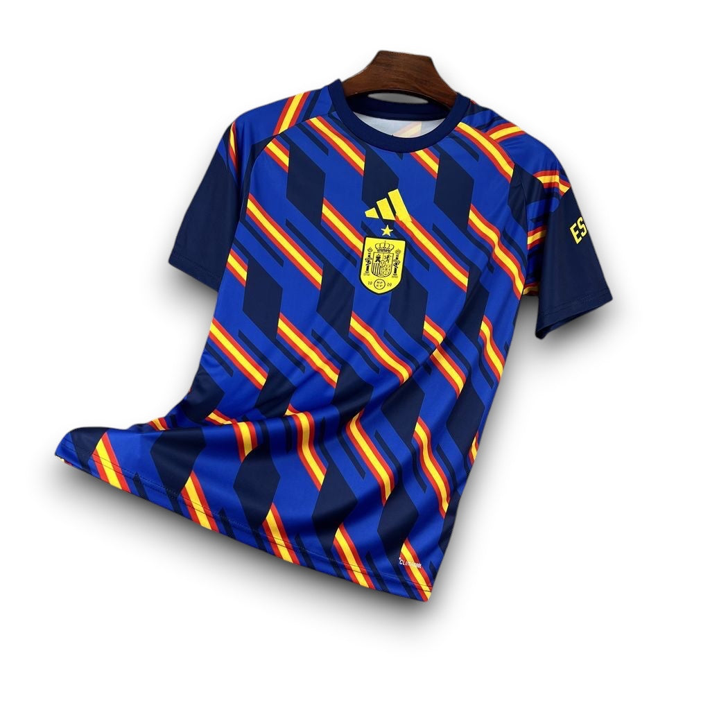 Leazofoot Spain 2026 pre-match football jersey with blue, yellow, and red diagonal stripes and crest.