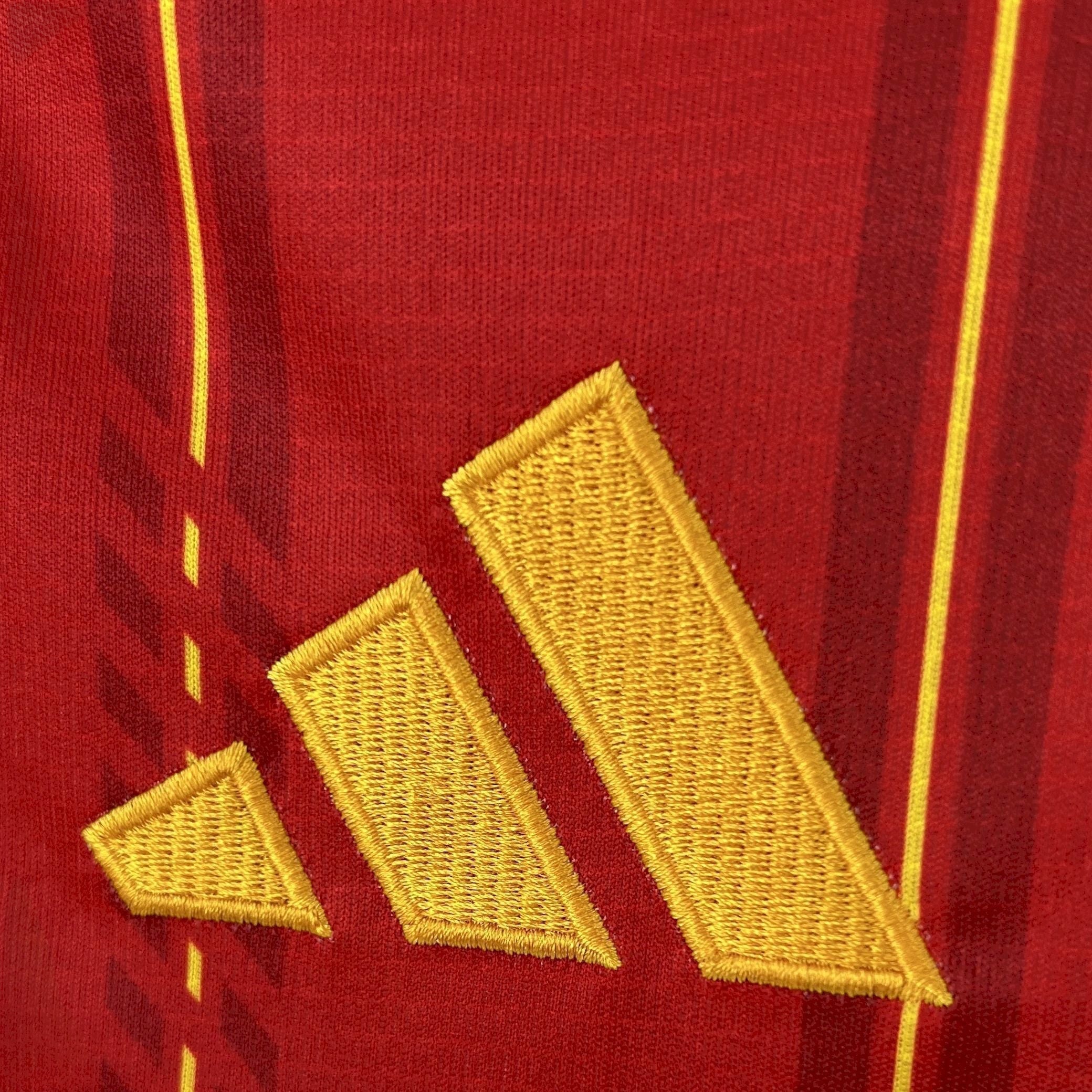 Leazofoot Spain 2026 home jersey with red and yellow striped pattern and embroidered logo.