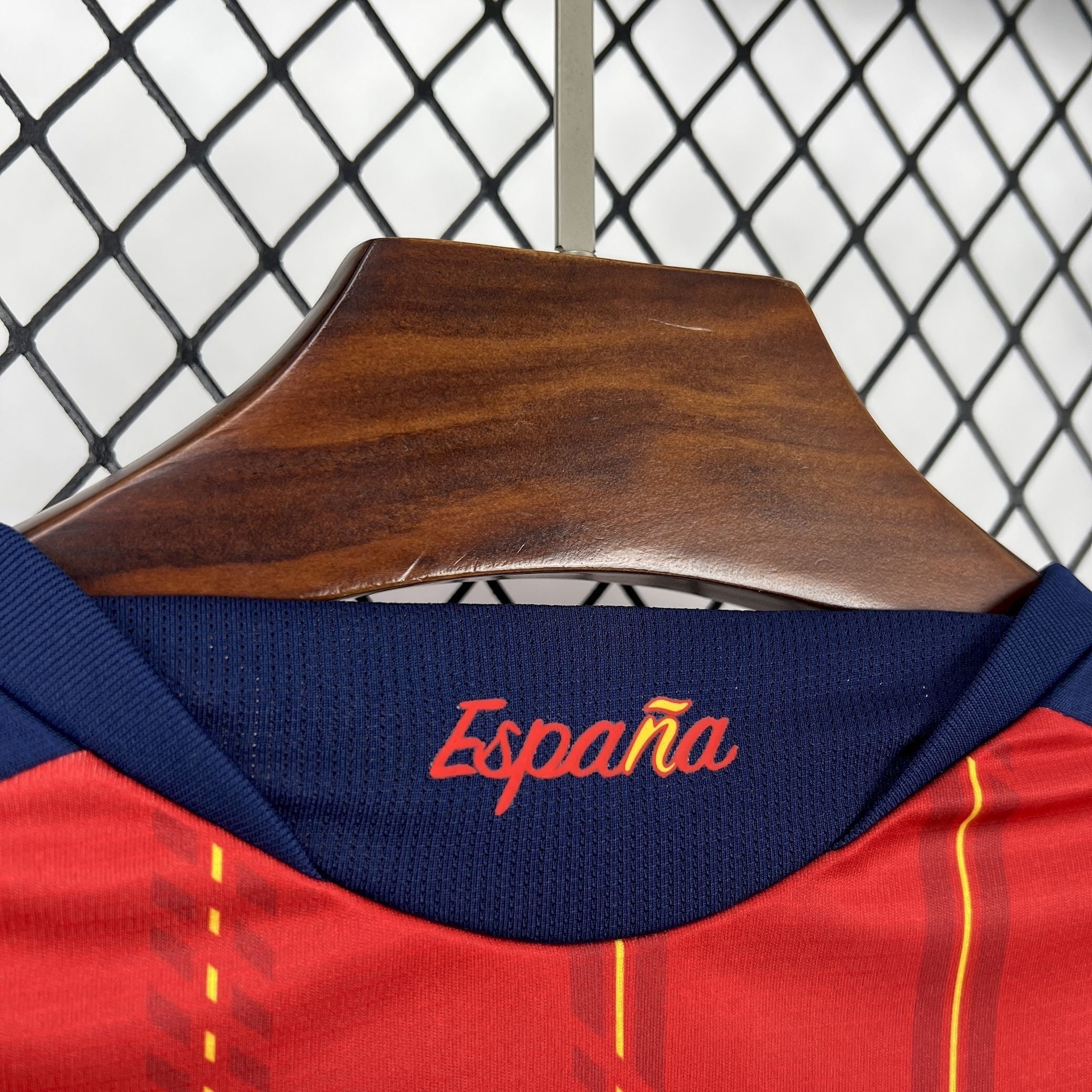 Leazofoot Spain 2026 home jersey in red with yellow pinstripes and navy blue collar featuring embroidered "España"