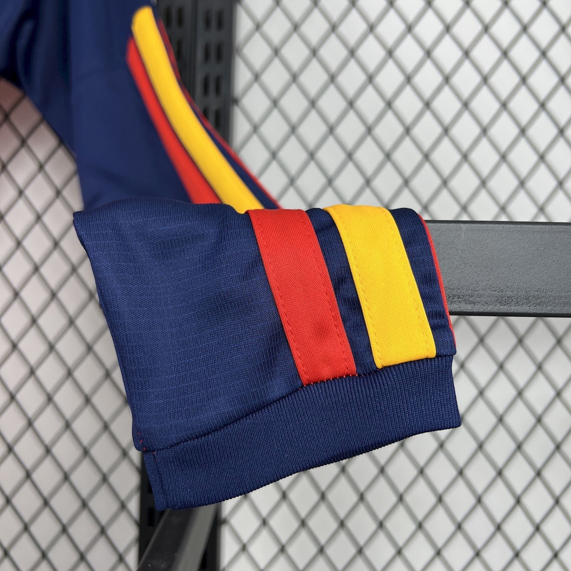 Leazofoot navy blue long sleeve jersey with red and yellow stripes on the cuffs and sleeves.