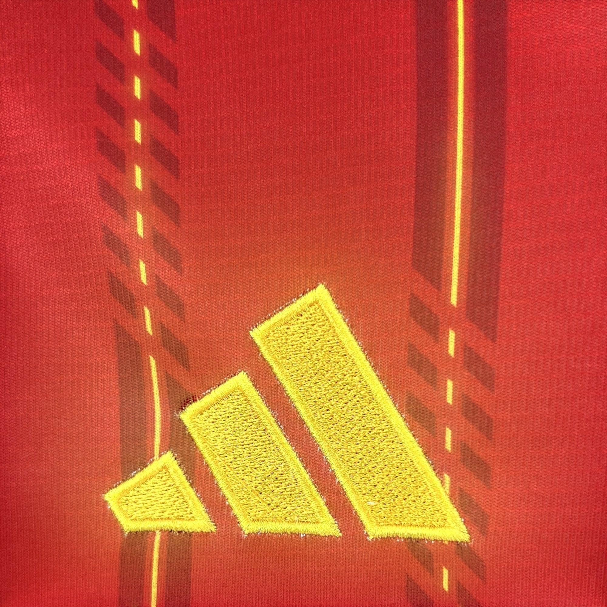 Leazofoot Spain long sleeve home jersey 2026 in red with yellow Adidas logo and stripe details.