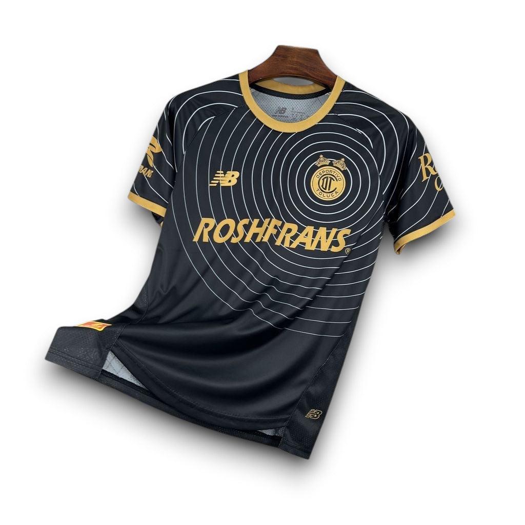 Leazofoot Toluca 26/27 concept soccer jersey in black with gold accents, circular graphic pattern, and team crest.