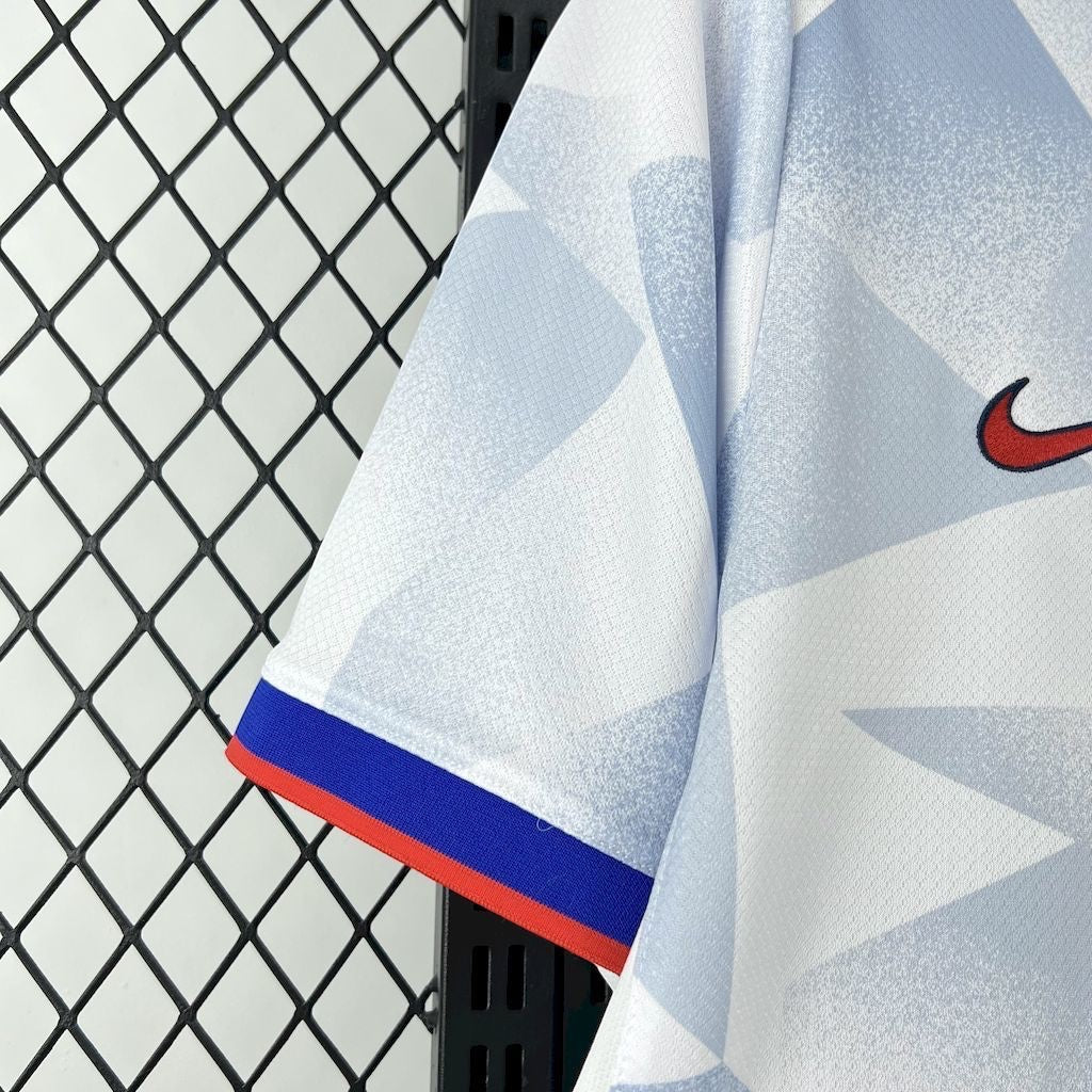 Leazofoot USA 2025 home soccer jersey in white with blue geometric pattern, red trim on sleeve, and Nike logo.