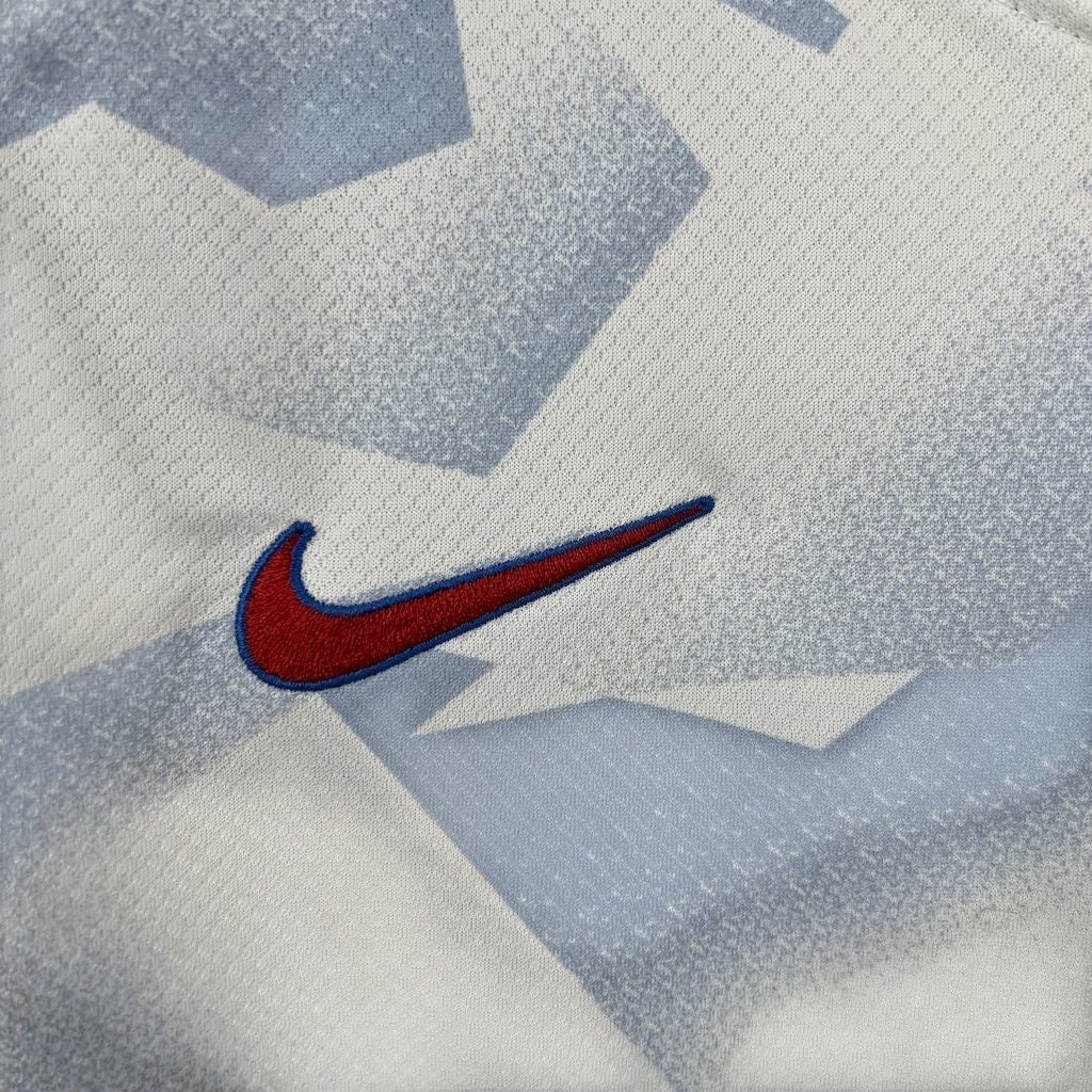 Leazofoot USA 2025 home kids soccer jersey featuring a white and blue geometric pattern with an embroidered red swoosh