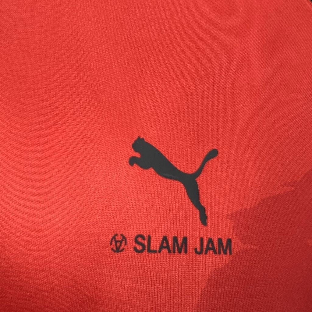 Leazofoot AC Milan 26/27 third jersey in red featuring a black Puma logo and Slam Jam branding detail.