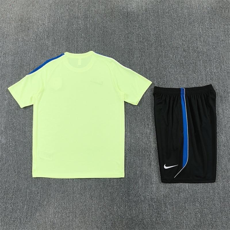 Leazofoot Atletico Madrid 26/27 training kit featuring a neon yellow t-shirt and black shorts with blue accents.