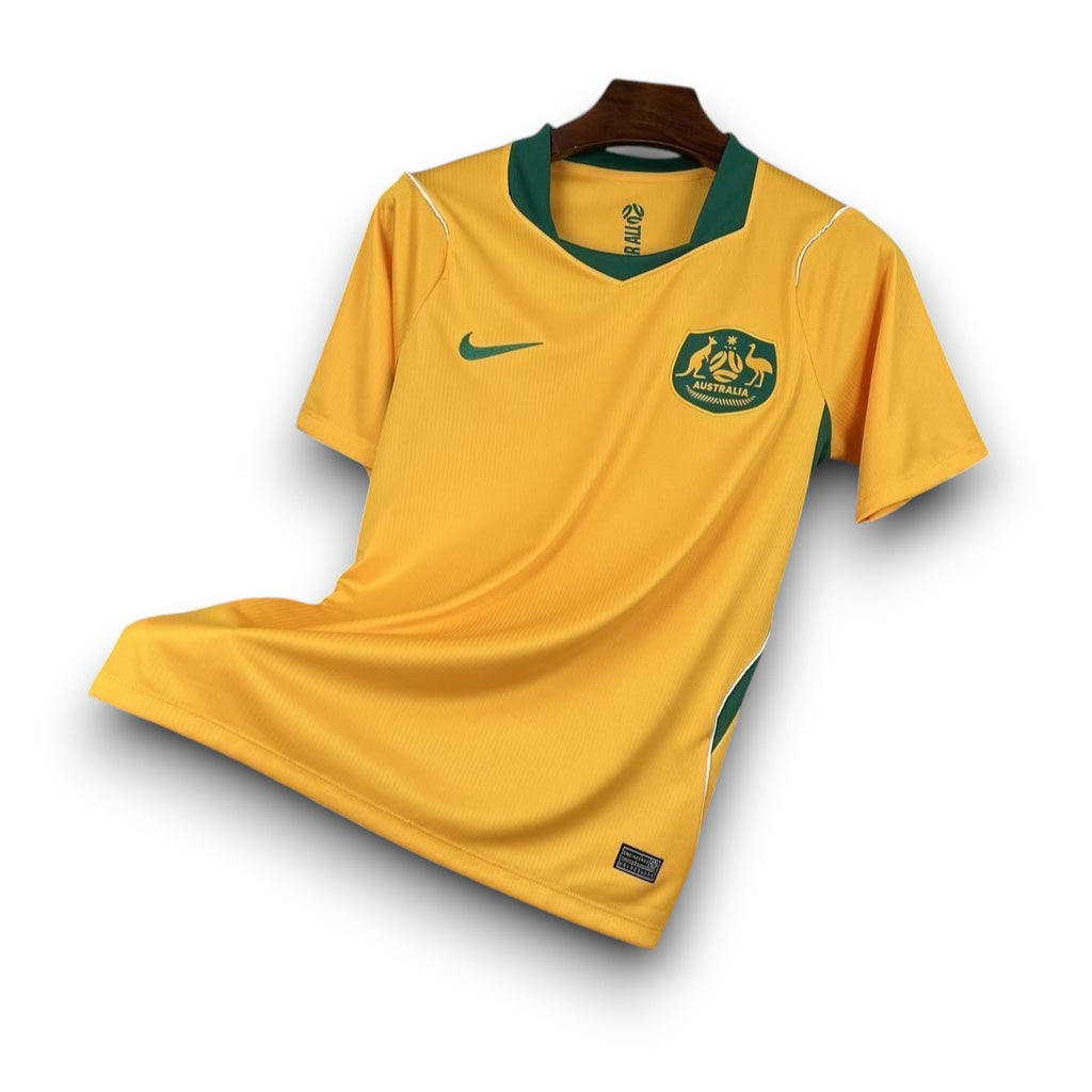Leazofoot Australia home soccer jersey 2026, yellow with green trim and collar, featuring the Australian coat of arms.