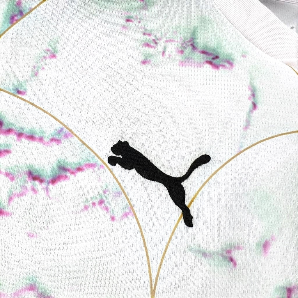 Leazofoot Austria 2026 away jersey featuring a white fabric with abstract green and pink patterns and gold accents.