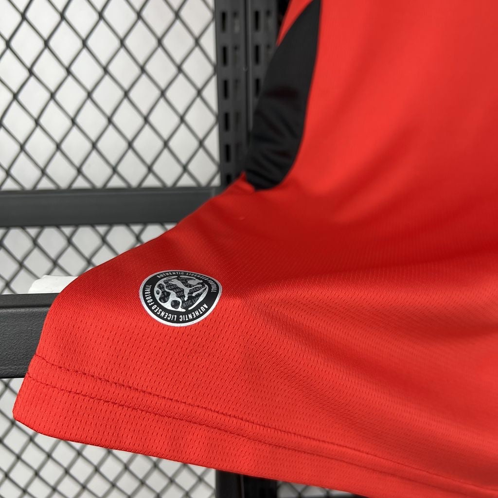 Leazofoot Austria 2026 home football jersey in red with black side panels and authentic licensed product badge.