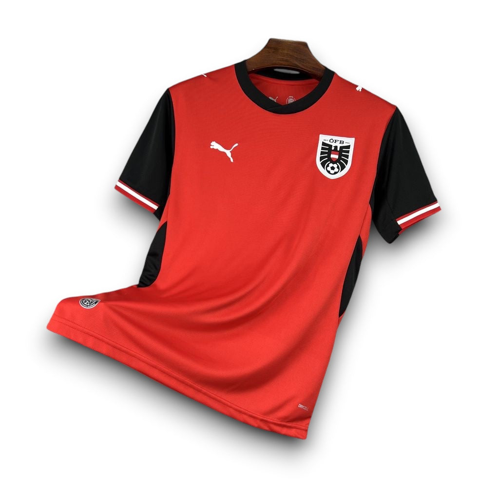 Leazofoot Austria 2026 home football jersey in red and black with team crest and Puma logo on a display rack
