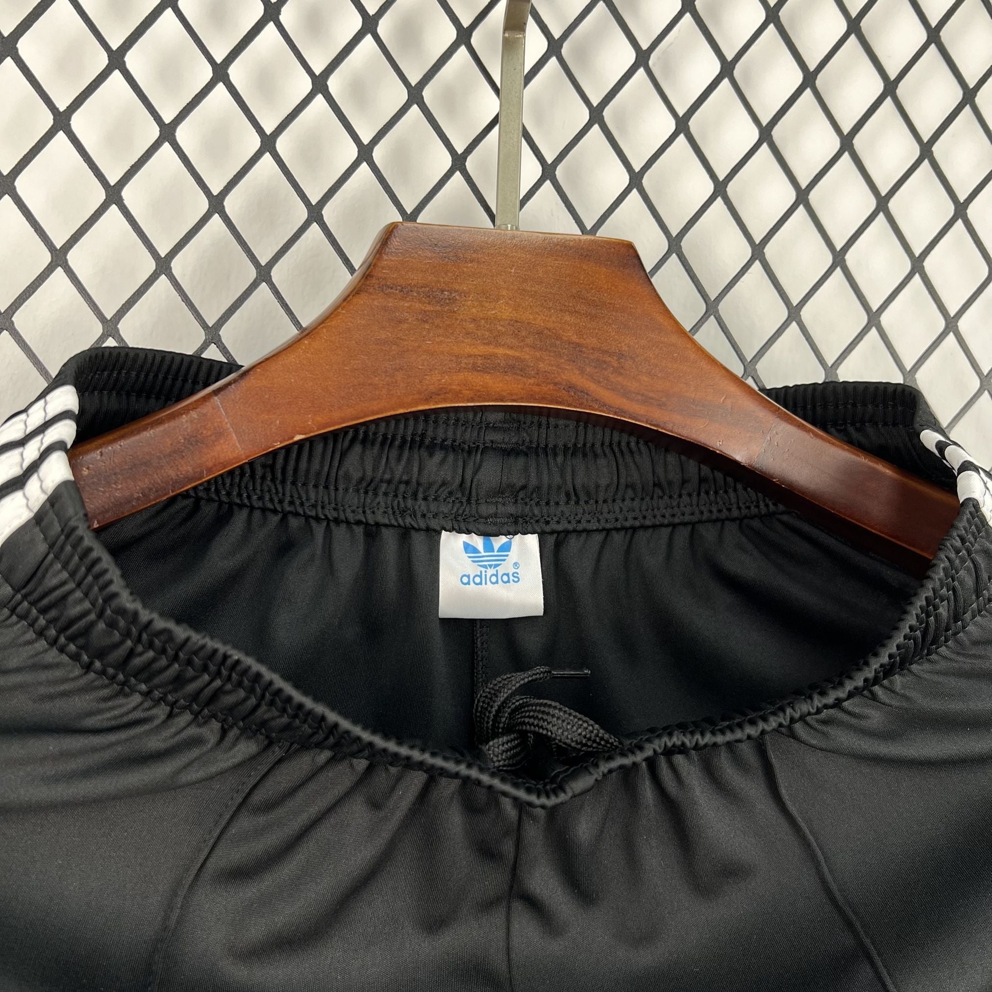 Leazofoot black athletic shorts with white Adidas stripes on the sides and drawstring waist.