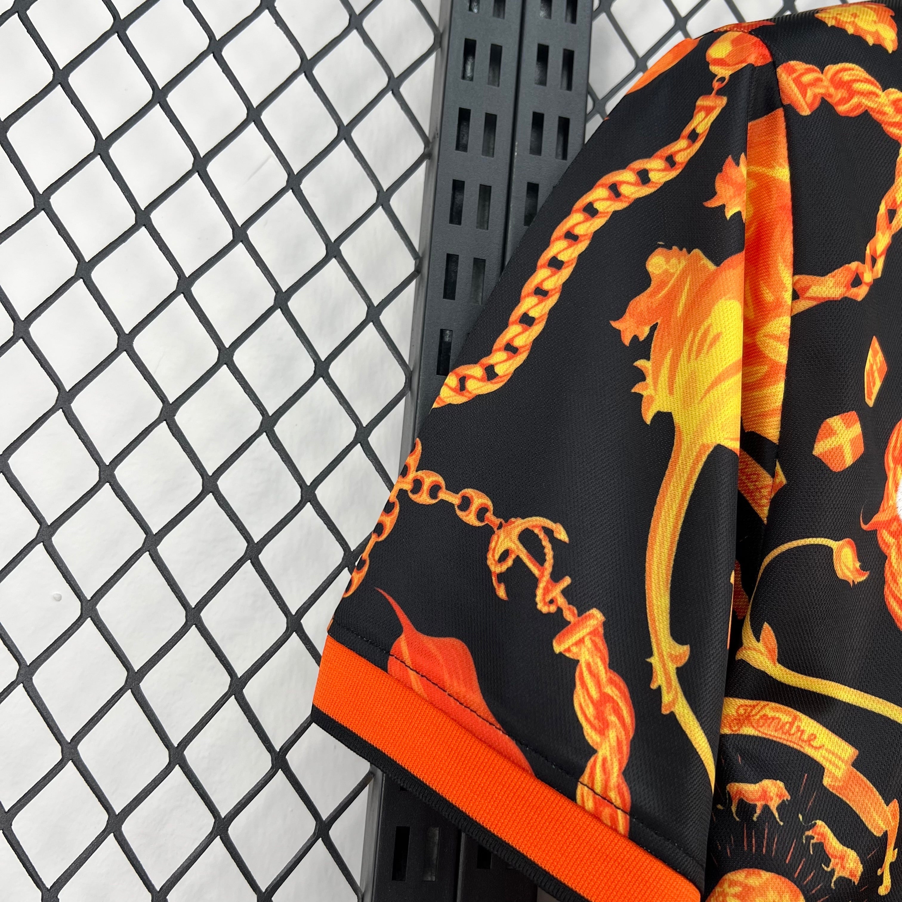 Leazofoot black pre-match football shorts with gold chain and lion print, orange trim.