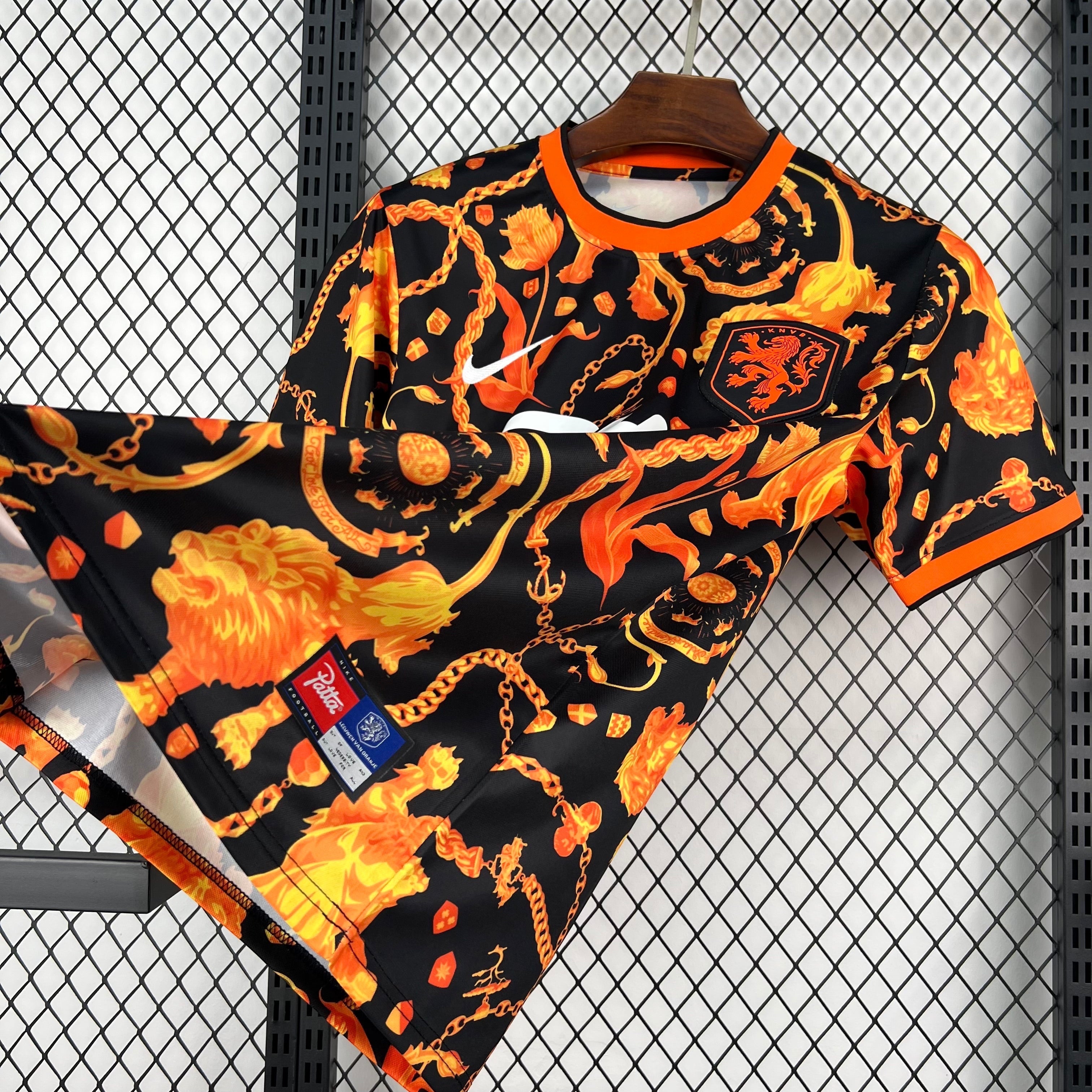 Leazofoot black and orange patterned football jersey with lion and chain motifs. Short sleeves, crew neck.