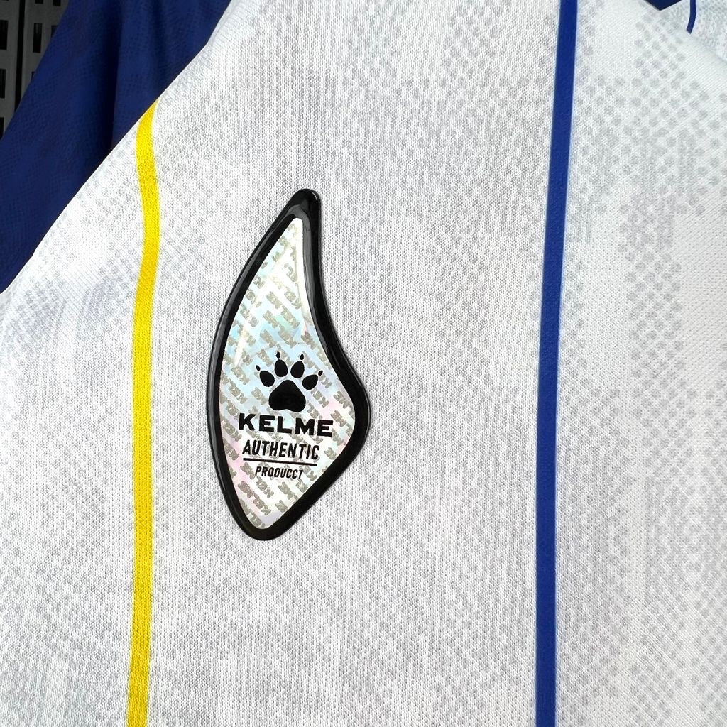 Leazofoot BOSNIE 2026 away jersey with white, blue, and yellow accents. Features a textured fabric and a KELME AUTHENTIC PRODUCT logo.