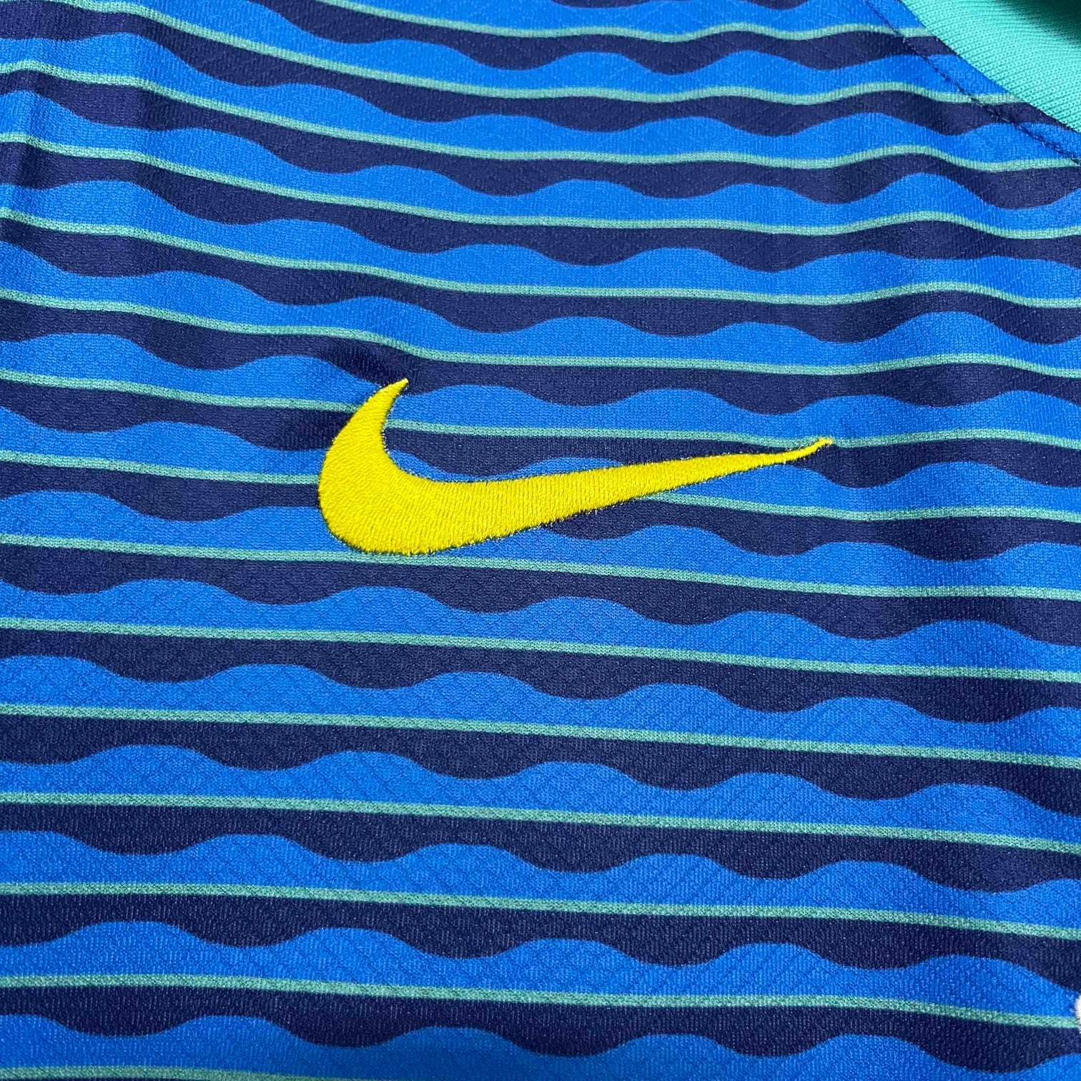 Leazofoot Brazil 2024 away jersey featuring blue and navy wavy striped pattern with an embroidered yellow Nike swoosh.