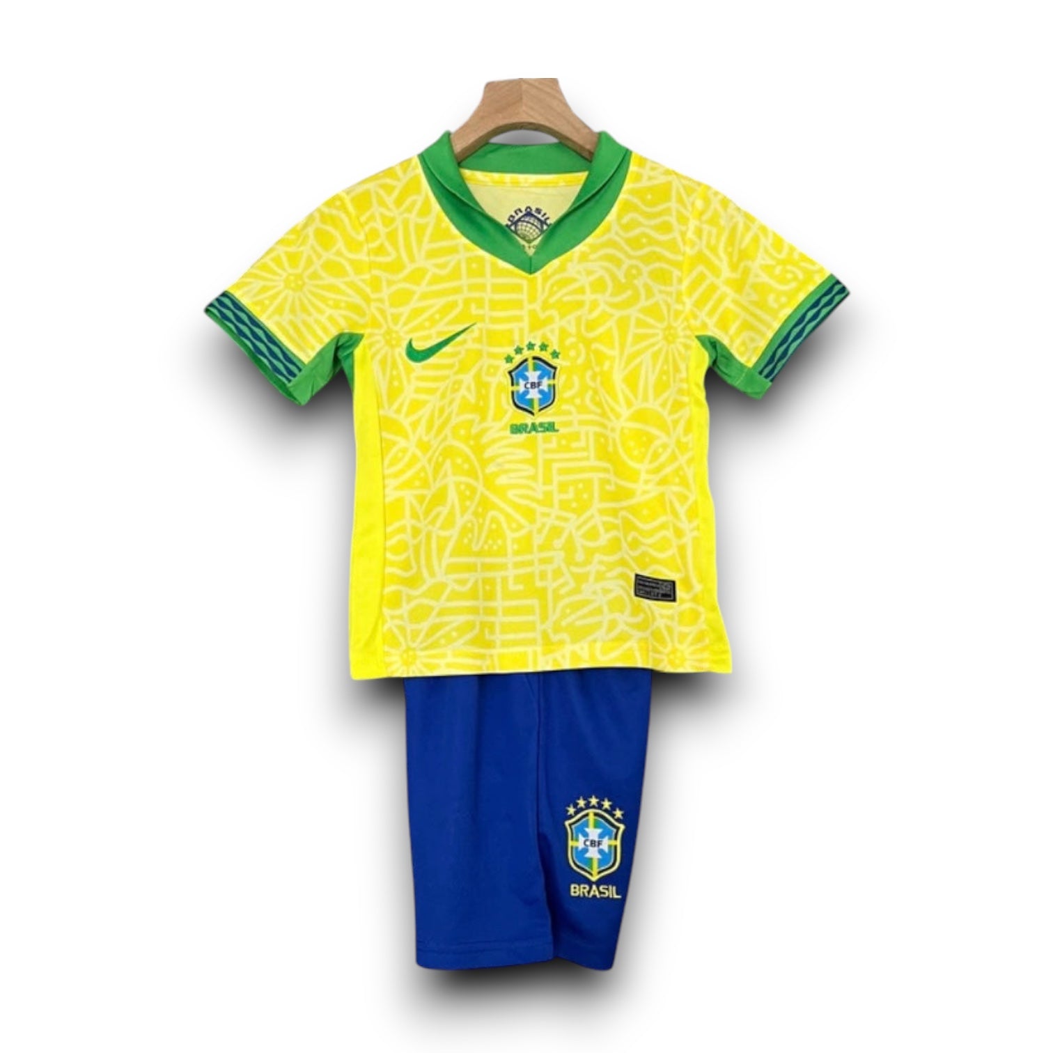 Leazofoot 2024 Brazil kids home kit featuring a yellow patterned jersey with green trim and blue matching shorts.