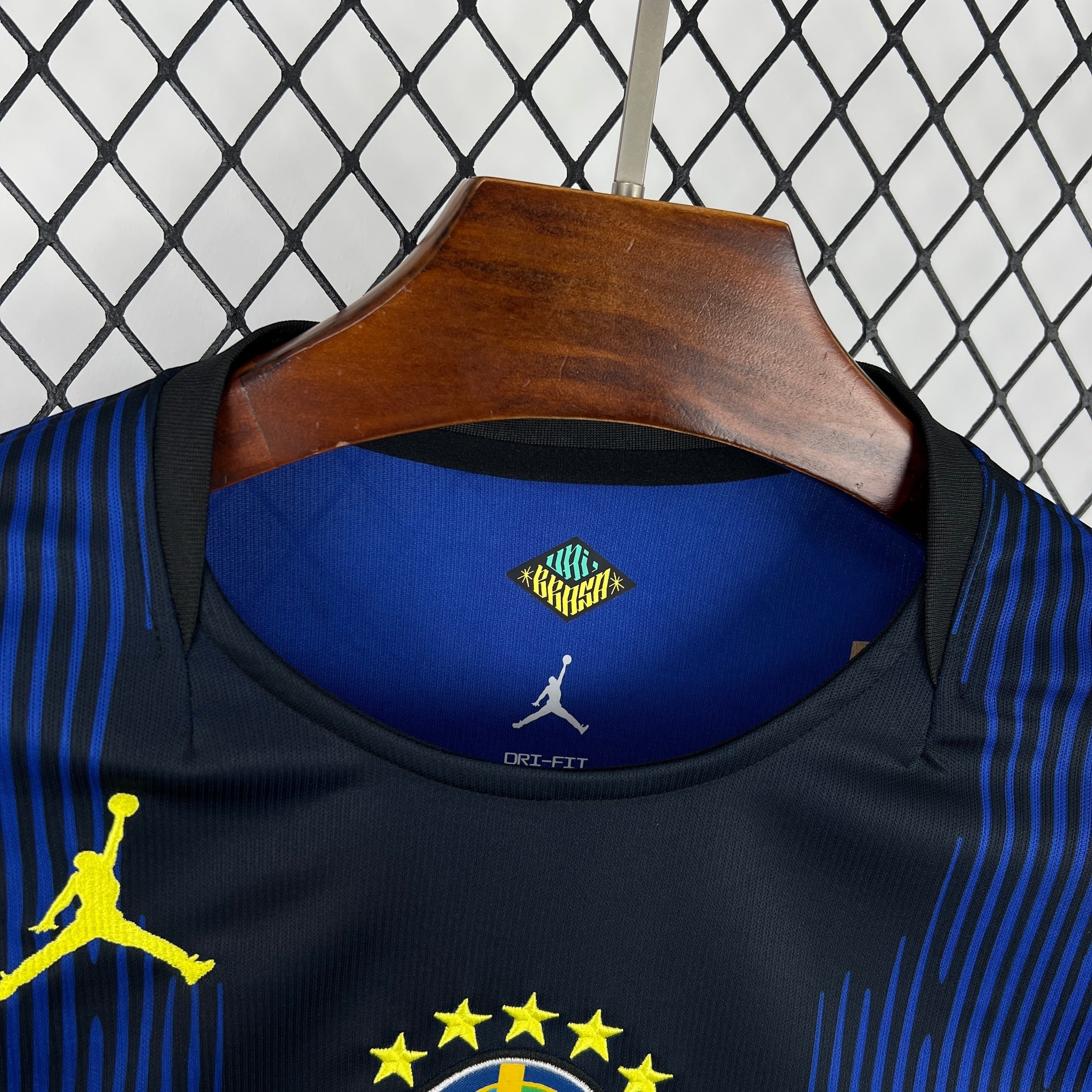 Leazofoot black and blue striped long sleeve soccer jersey with yellow Jumpman logo and Dri-FIT technology.