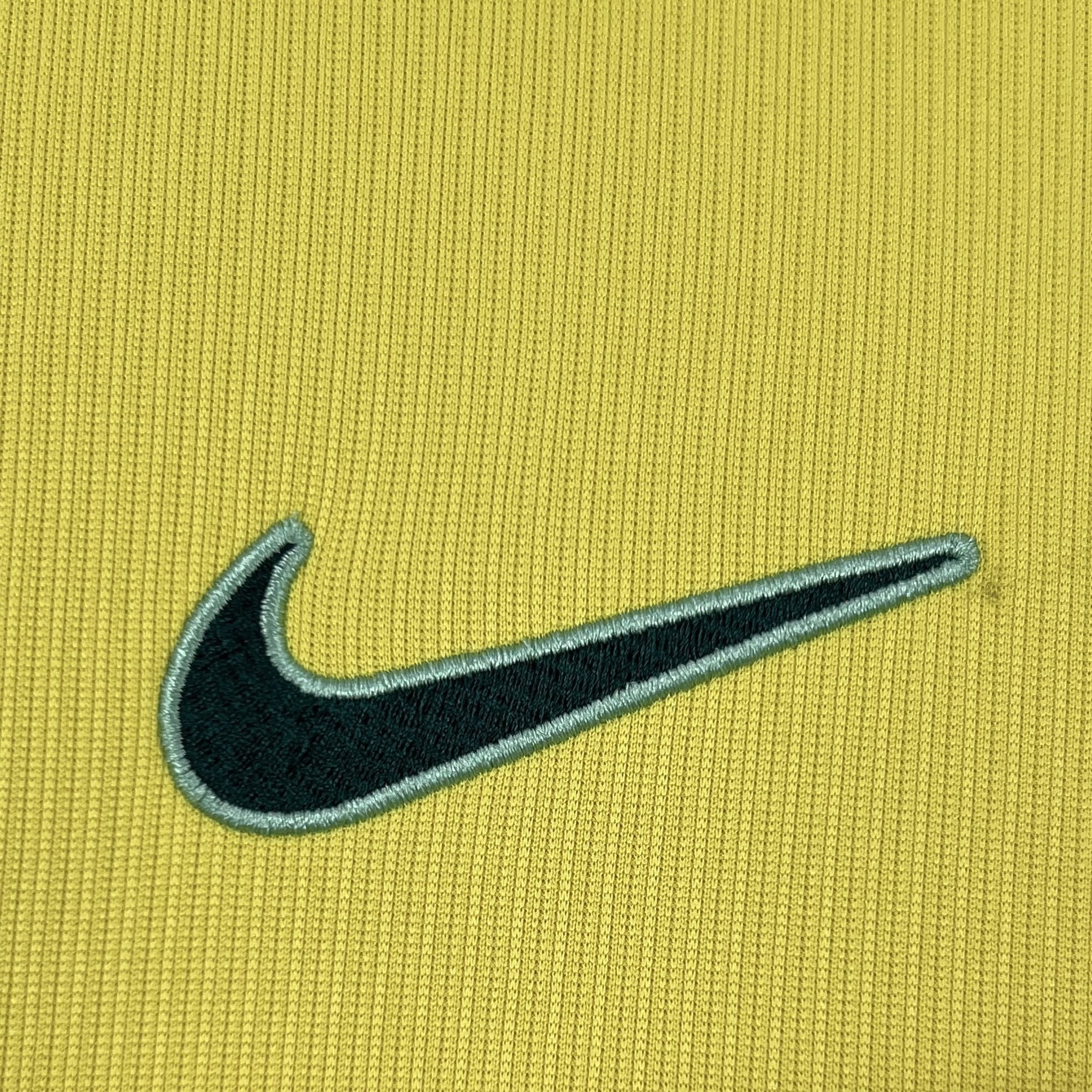 Leazofoot BRÉSIL 2026 home jersey in yellow with embroidered black Nike logo and light blue trim.