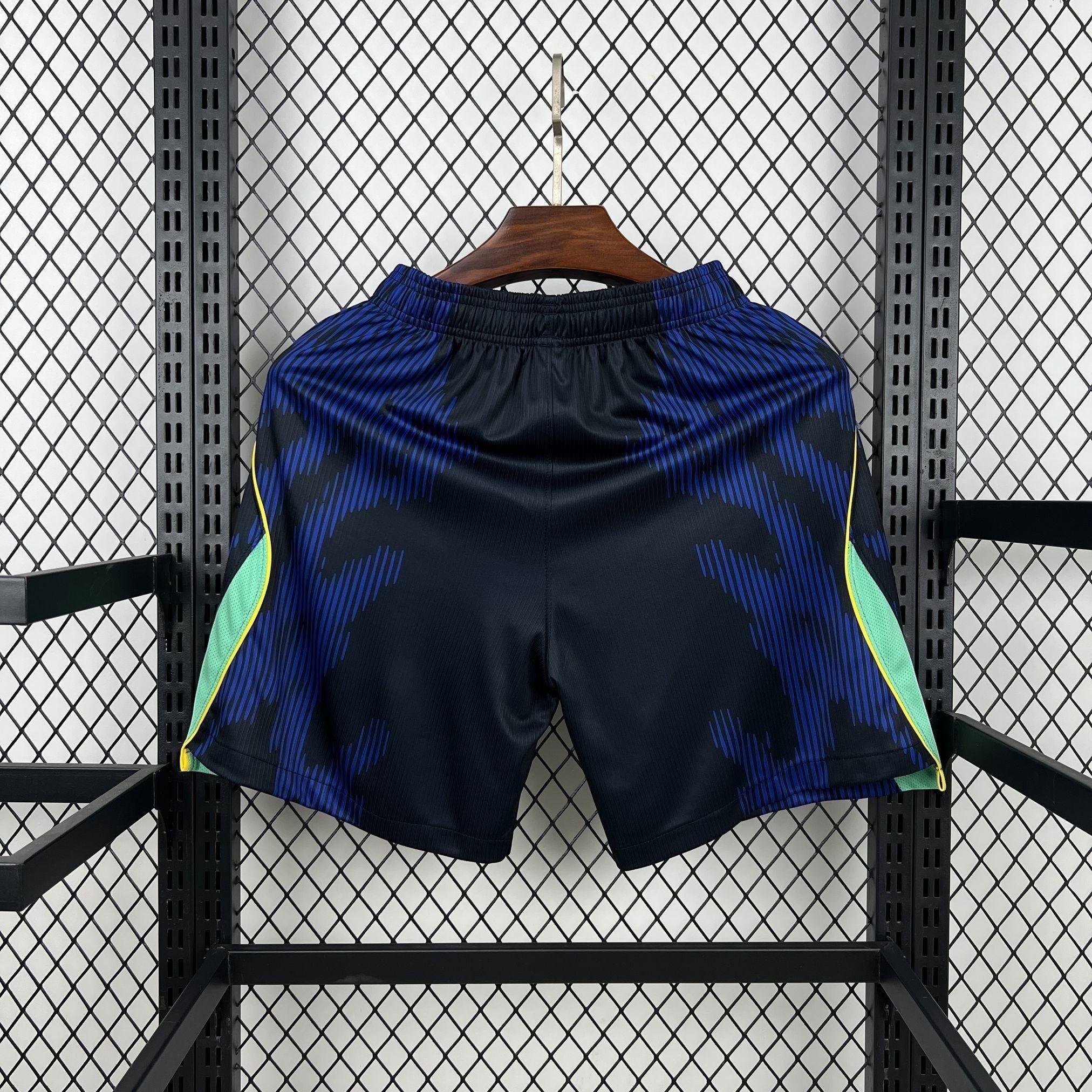 Leazofoot BRÉSIL - SHORT EXTÉRIEUR 2026 black athletic shorts with blue abstract pattern and lime green side panels.