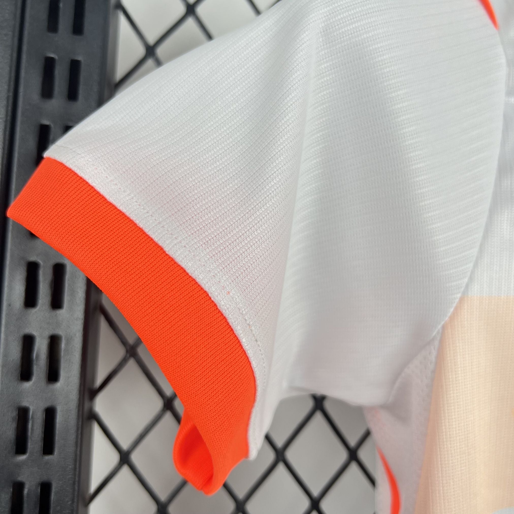 Leazofoot white and orange children's outdoor set with short sleeves and textured fabric.