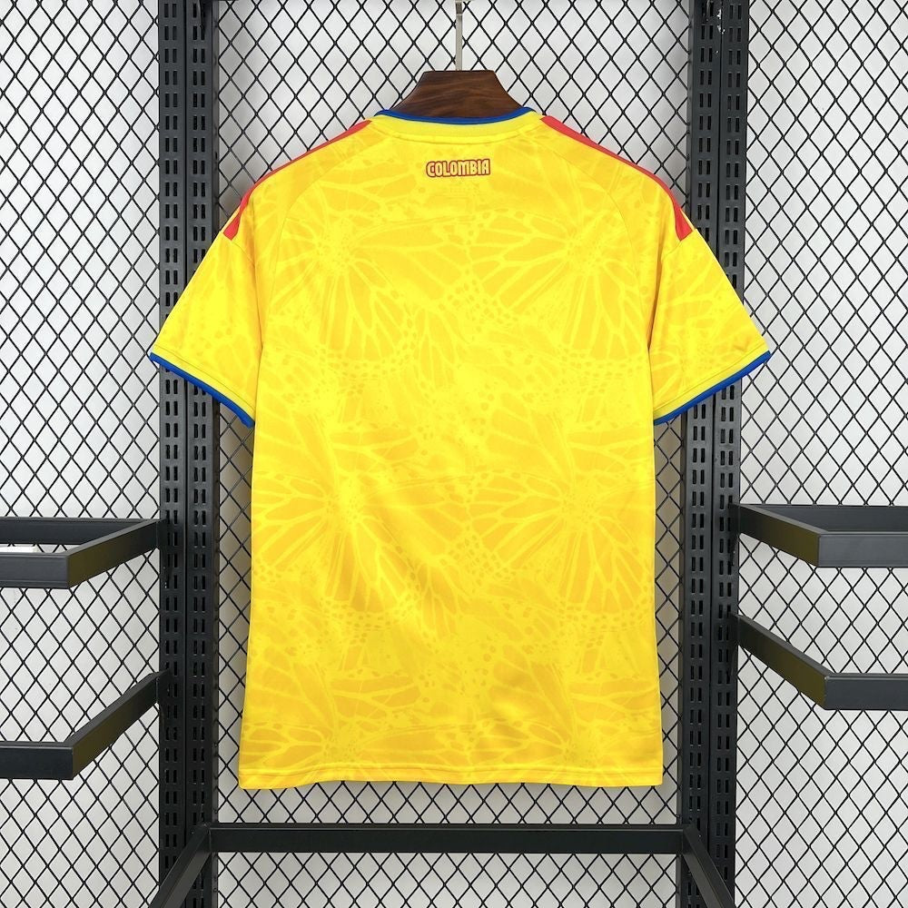 Leazofoot COLOMBIE 2026 home soccer jersey, bright yellow with a subtle butterfly wing pattern and blue trim on the collar and sleeves.